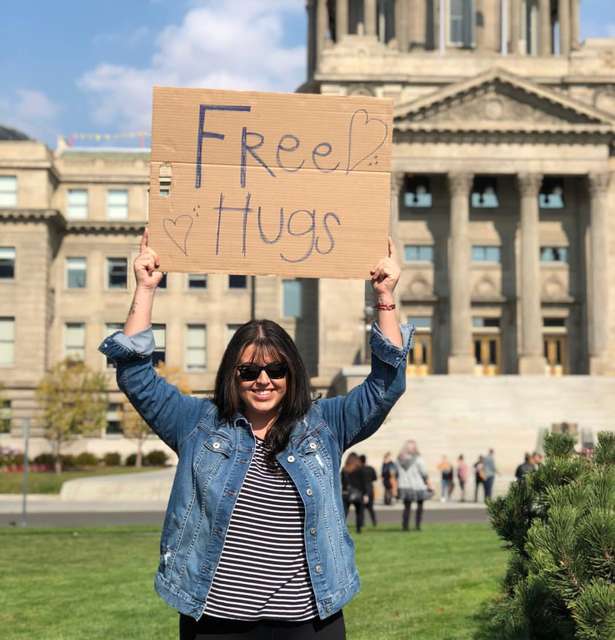 Future Professional Holding Free Hugs Sign